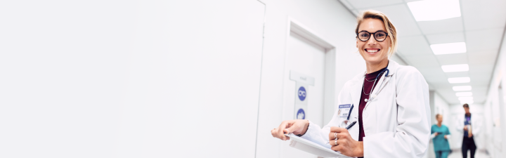 Eine junge Ärztin lächelt in die Kamera